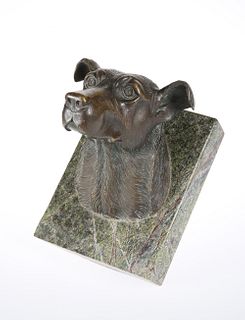A BRONZE MODEL OF A HOUND'S HEAD MOUNTED ON MARBLE, modelled with ears pric