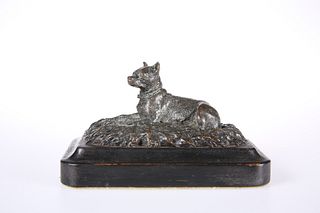A 19th CENTURY DESK BRONZE OF A RECUMBENT DOG, modelled on a naturalistic b