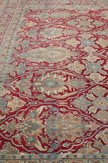 A LARGE KERMAN CARPET, with a red ground. Approx. 630cm by 389cm