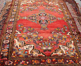 A MALAYER CARPET, the central medallion picked out in bright colours, on a 