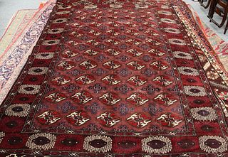 A TURKEMAN CARPET, the centre with a repeating design of fifty medallions. 