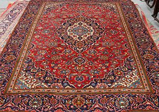 A KASHAN CARPET, with a central medallion within a blue ground medallion, a
