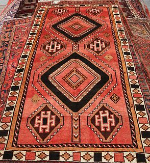 A KASHGAR CARPET, with two primary medallions and six smaller to a red grou