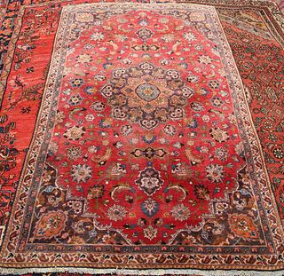 A MASHAD CARPET, with central medallion eight outer petals, on a red ground