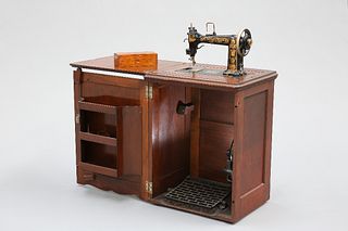 A CABINET TREADLE SEWING MACHINE BY WHEELER & WILSON, no. 2635068, decorate