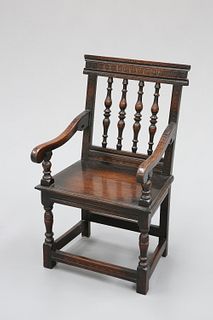 A VICTORIAN CARVED OAK CHAIR, IN 17TH CENTURY STYLE, with five-spindle back