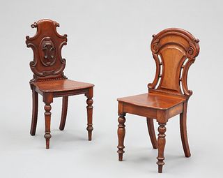 TWO VICTORIAN MAHOGANY HALL CHAIRS, each with carved back, raised on turned