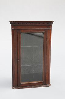 A SMALL GLAZED MAHOGANY CORNER CUPBOARD, with dentil cornice and shaped she