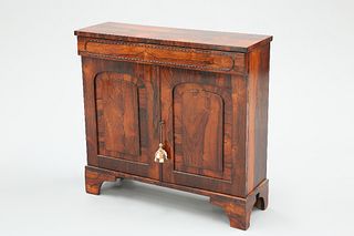 A REGENCY ROSEWOOD SIDE CABINET, the moulded frieze drawer above a pair of 