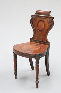 A REGENCY MAHOGANY HALL CHAIR, with scroll carved back above a bell shaped 