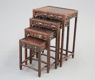 A NEST OF FOUR CHINESE HARDWOOD TABLES, CIRCA 1900, each with panel inset t