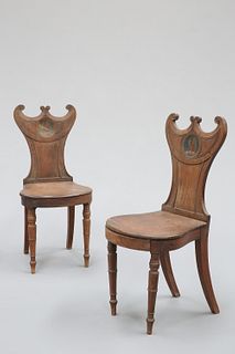 A PAIR OF REGENCY MAHOGANY HALL CHAIRS, with paired C-scroll crests above a