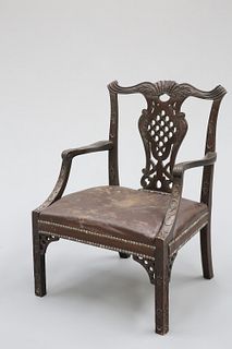 A MAHOGANY OPEN ARMCHAIR, IN THE IRISH CHIPPENDALE TASTE, the crest rail ce