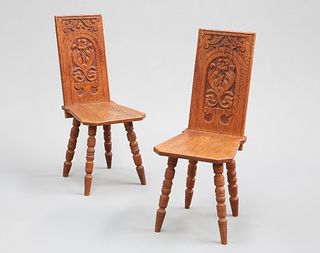 A PAIR OF VICTORIAN CARVED OAK HALL CHAIRS, each rectangular back carved wi