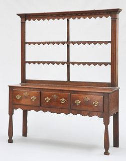 A GEORGE III OAK DRESSER AND RACK, the rack with dentil cornice above a pen
