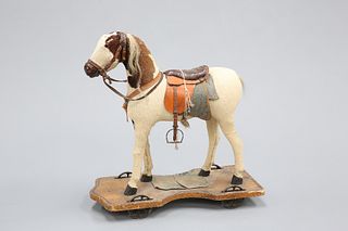 A 19TH CENTURY PUSH-ALONG HORSE, with hide body, horse hair mane and tail, 