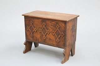 A SMALL BOARDED OAK CHEST, the lid with chip carved edge to each side, the 