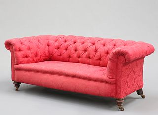 A VICTORIAN BUTTON-BACK CHESTERFIELD SOFA, raised on turned legs and moving