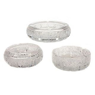 Three cut crystal ashtrays.