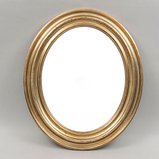 Espejo. Siglo XX. Diseño oval. Elaborado en madera dorada. Con luna oval. 65 x 55 x 4 cm.