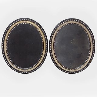 Pair of Irish Ebonized Parcel-Gilt and Beaded Glass Oval Mirrors
