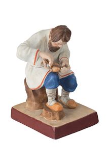A RUSSIAN PORCELAIN FIGURE OF A BAST SHOE MAKER, GARDNER PORCELAIN FACTORY, MOSCOW, LATE 19TH CENTURY 