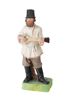A RUSSIAN PORCELAIN FIGURE OF A BALALAIKA PLAYER, GARDNER PORCELAIN FACTORY, MOSCOW, LATE 19TH CENTURY 