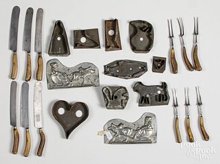 Tin cookie cutters, together with flatware