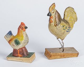 Two painted composition rooster squeak toys