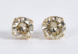 Pair of 14K gold diamond stud earrings.