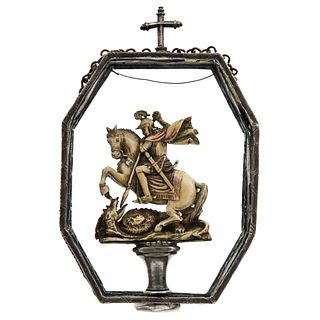 RELIQUARY WITH FIGURE OF ST. GEORGE AND THE DRAGON. 18th-19th Century. Carved in polychromed ivory. Encapsulated in medallion.