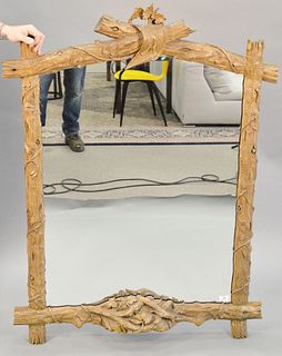 Carved Black Forest style framed mirror, carved with branch, vine and leaves, 50" x 39".