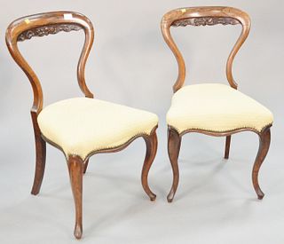 Set of six rosewood Victorian balloon-back dining chairs, front cabriole legs, carved foliate design to upper back, with studded and upholstered seats