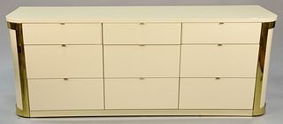 John Stewart nine-drawer commode, mid-century design, graduated drawers with brass tab pulls, lacquered finish, gold metal trim, signed in drawer, ht.