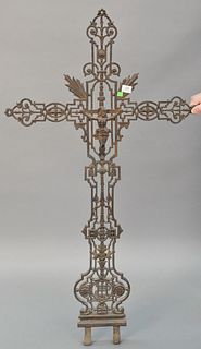 Large metal cross with pierced scrolling motif and crucified Christ at center, two prongs at base, light wear, 55 1/2"h. x 29" w., [Provenance: Former