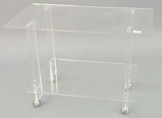 Contemporary lucite table, two tiers, on castor wheels, light surface wear, 21" h. x 30" w. x 16" d., [Provenance: Estate of William and Teresa Patton