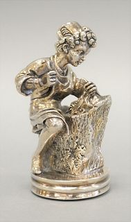 Sterling silver figure seated boy with tools, 5 1/4".