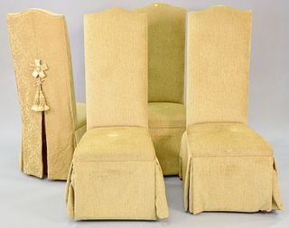 Set of four fully upholstered dining chairs, tan with robe ties to back, 42" h.