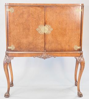 Continental burl walnut two door cabinet on tall cabriole legs terminating in carved paw feet, 58" h. x 46 1/2" w. x 19" d.