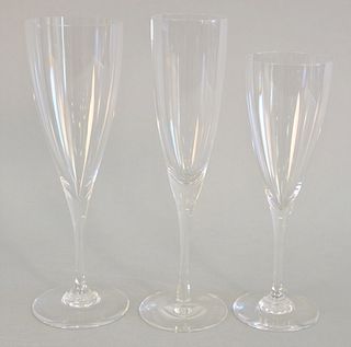 Thirty-two Baccarat champagne glasses, largest 9 1/2", all signed on base.  [Property from the Collection of Ginny and Henry Mancini].
