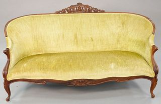 Victorian rosewood sofa, central carved foliate crest, green upholstery, 39" x 76".
