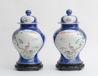 PAIR OF CHINESE BLUE-GROUND FAMILLE ROSE PORCELAIN BALUSTER-FORM JARS AND COVERS