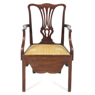 A Chippendale Carved and Figured Mahogany Convenience Armchair
