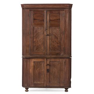 A Federal Carved and Paneled Walnut Corner Cupboard
