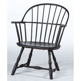 A Carved, Turned and Black-Painted Sack-Back Windsor Armchair