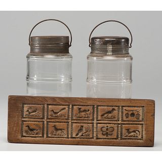 A Pair of Lidded Glass Jars and a Wooden Butter Mold
