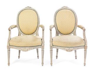 A Pair of Louis XVI Style Cream Painted Fauteuils Height 37 1/2 inches.