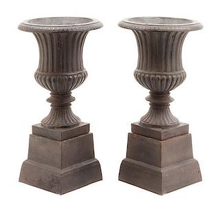 A Pair of Victorian Cast Iron Urns Height 19 3/4 inches.
