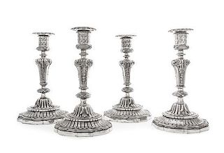 A Set of Four English Silver-Plate Candlesticks, 19th Century, with tied reeded borders and shaped circular feet.