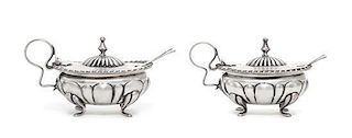 A Pair of Continental Silver Salts and Spoons, , each with gadrooned borders, raised on four feet, with glass liners.
